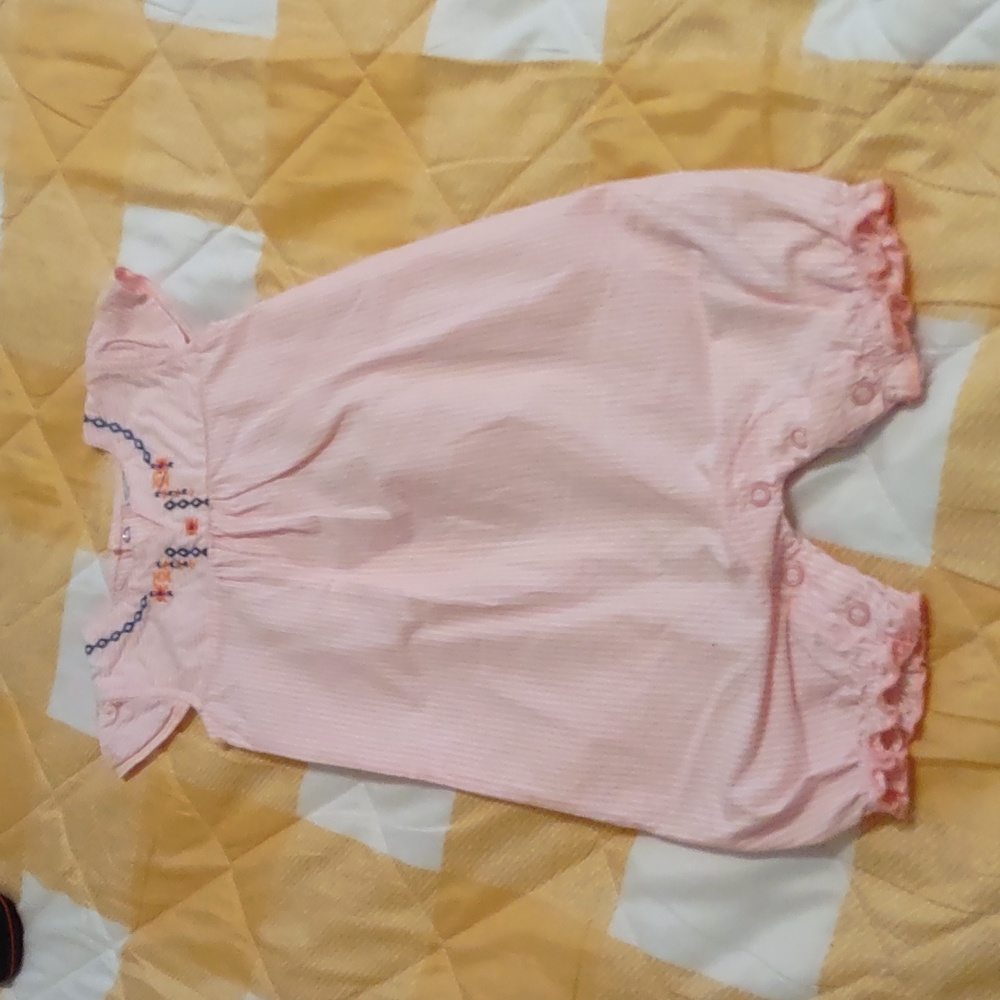 Infant romper with embroidery neckline.